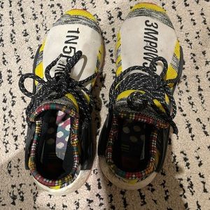 Pair of Adidas Human Race sneakers